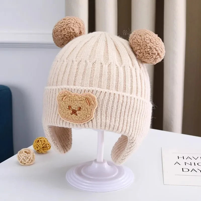 baby winter wool hat with bear ears displayed on a stand, featuring bear ears and a cute bear patch.