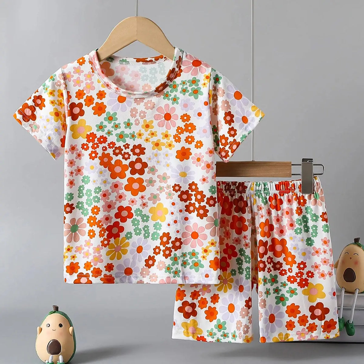 Kids pajama set featuring a colorful flower print t-shirt and shorts, perfect for playful sleepwear.