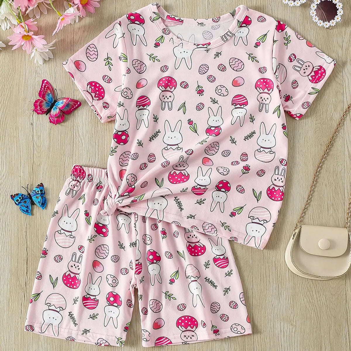 Kids pajama set featuring a cute bunny and mushroom print T-shirt and shorts in pink, perfect for comfortable sleep.
