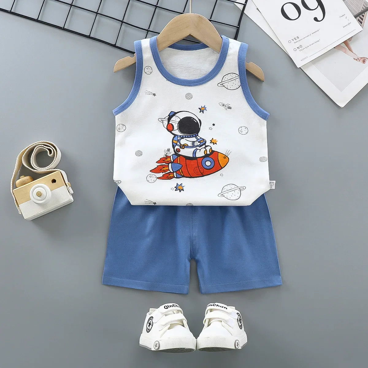 Kids summer outfit set featuring a cotton sleeveless tank top and shorts with a fun cartoon astronaut print.